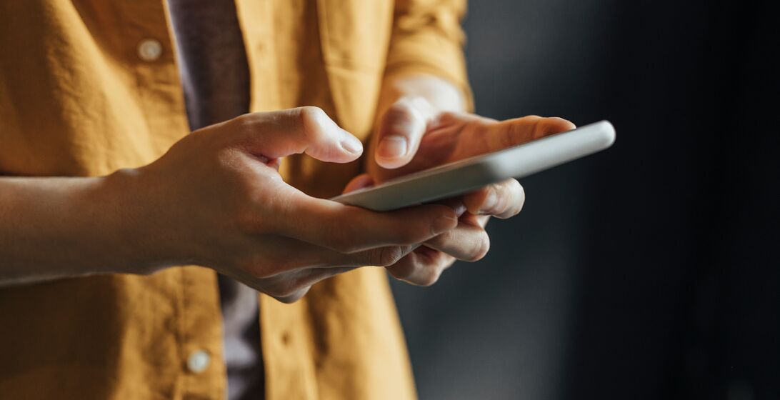 Anonymous Man Wearing a Yellow Shirt Using Modern Technology, a Close Up