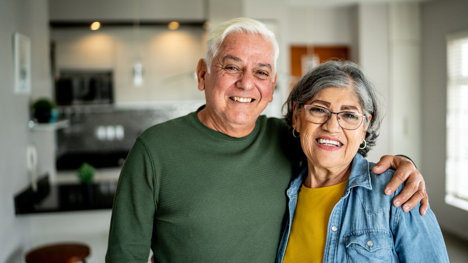 Portrait of a senior couple embracing at home