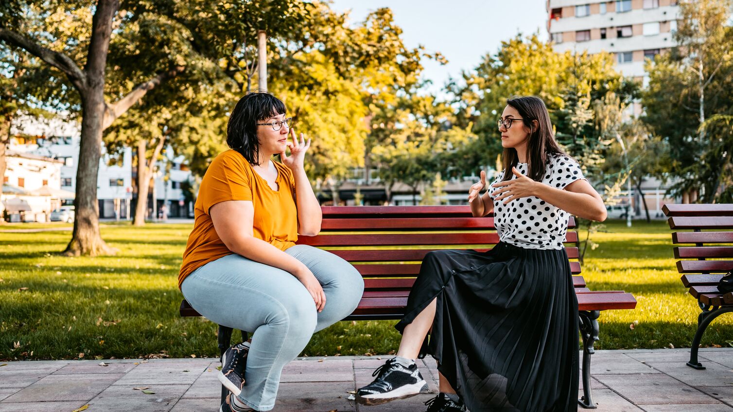 Friends at the park having a conversation using sign language