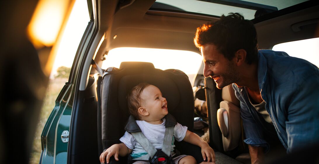 Photo of young father spending time with his son by taking him on a road trip in nature