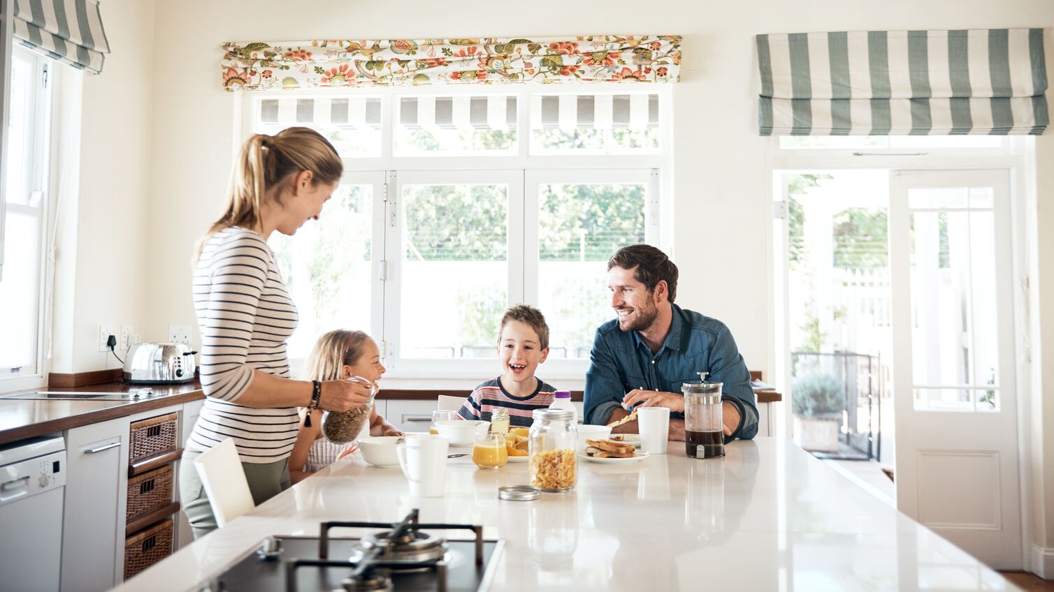 Shot of a happy family of four having breakfast together in the kitchen at home