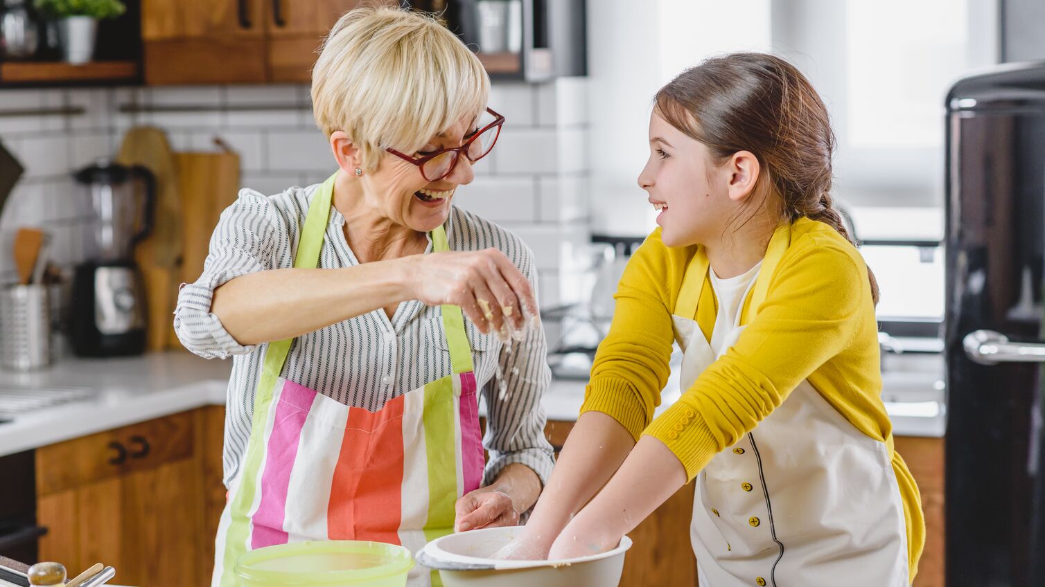Grandma cooking with her granddaughter