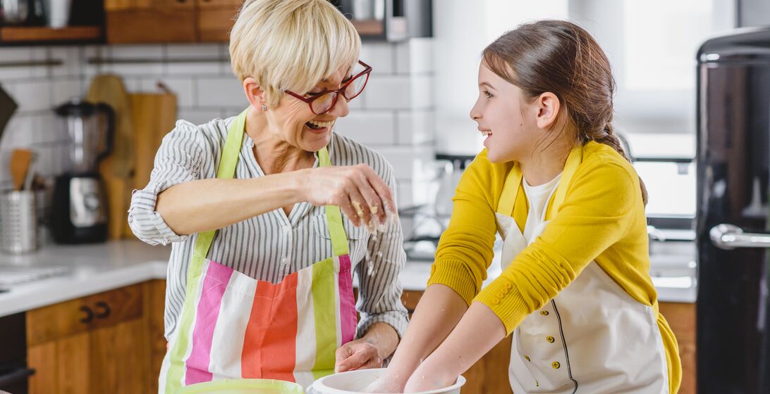 Grandma cooking with her granddaughter