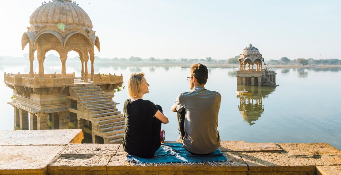 Gadi Sagar lake; she is at a public viewpoint, accessible without entry fee