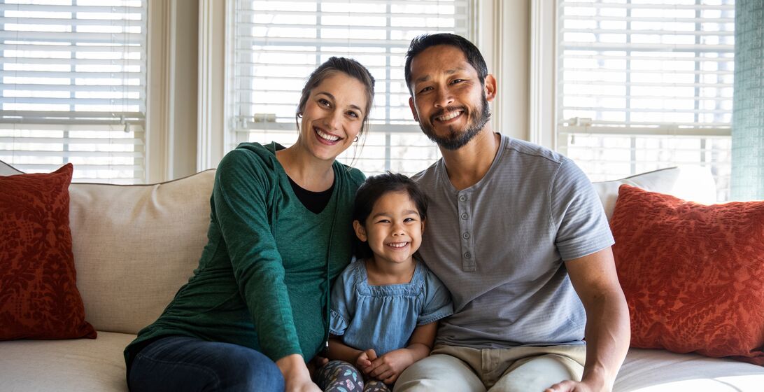 Portrait of family at home on sofa