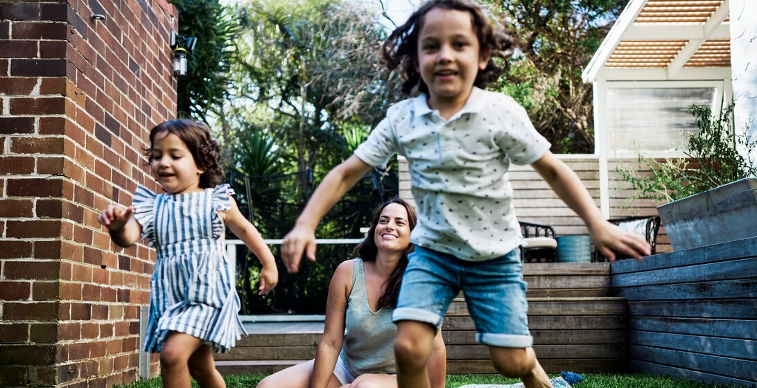 Kids and Their Mum Engaging in Creative Play in the Outdoor Oasis