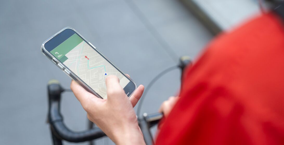 Delivery Man Checking Mobile App For Direction In the City