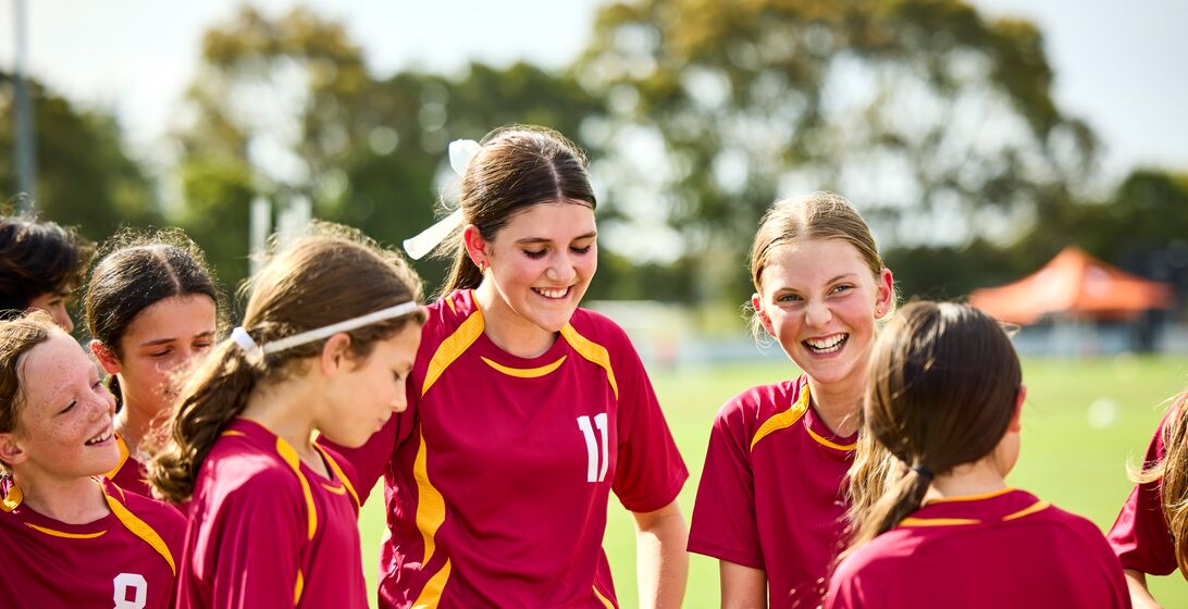 Girls' soccer team giggling as they are having fun