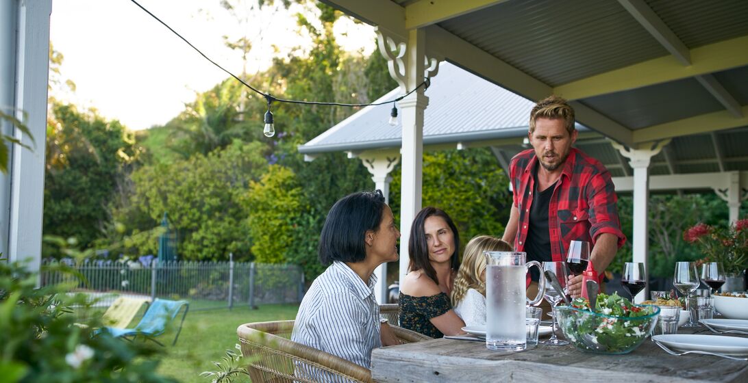 Cropped shot of a family having lunch together in their backyard