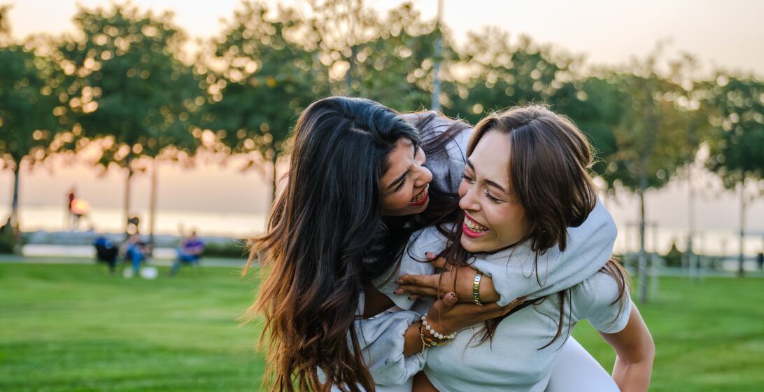 Young couple hugging playfully in a park