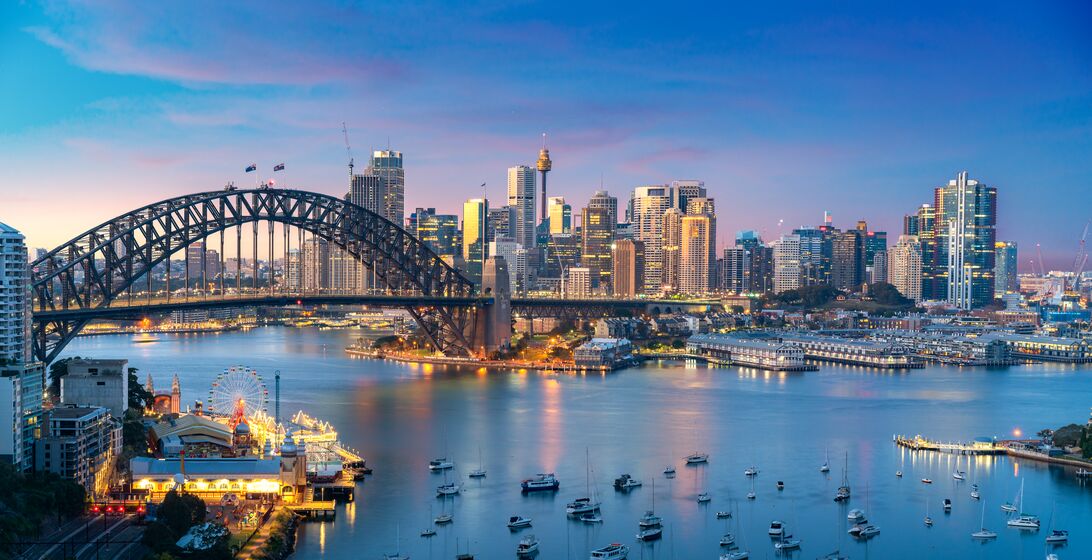 Cityscape image of Sydney, Australia with Harbor Bridge and Sydney skyline during sunset. Vacation and travel in Australia.
