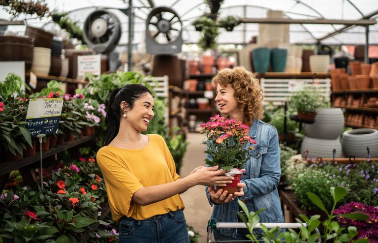 Friends buying plants at a garden center