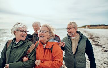 Close up of a group of seniors taking a walk by the beach