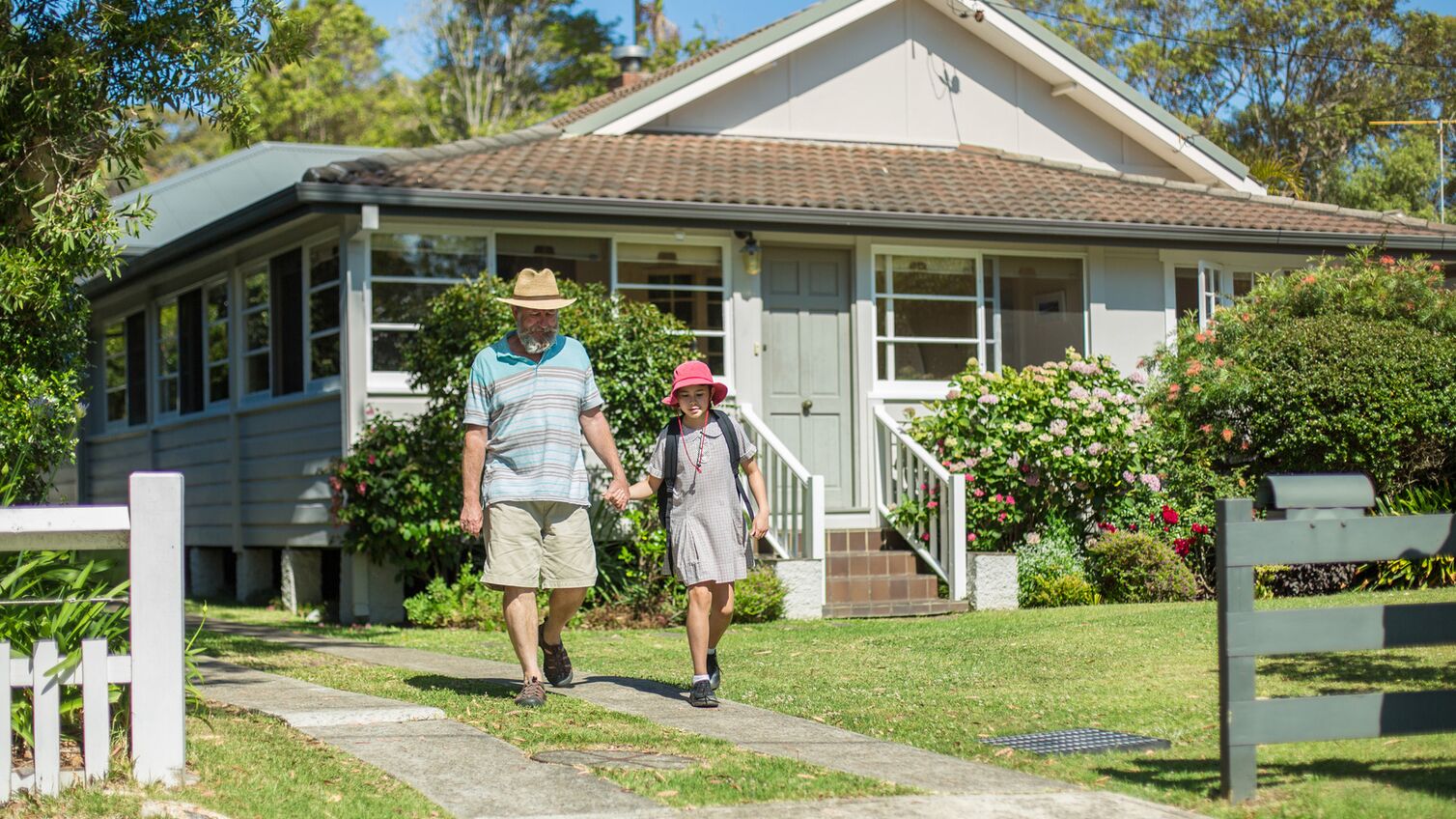 Father and daughter outside of their home