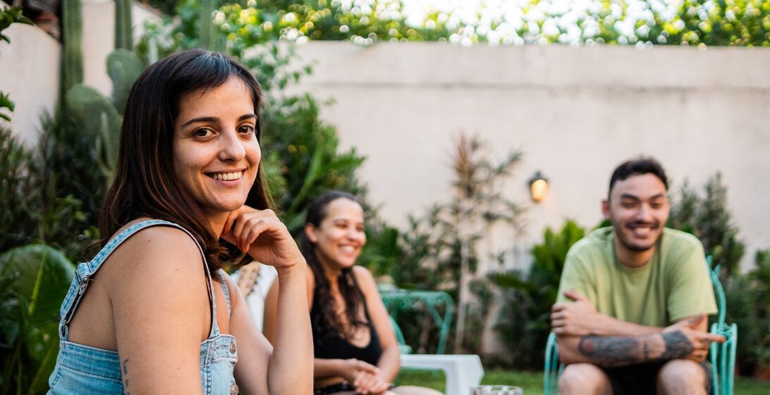 Portrait of a mid adult woman with friends in the backyard at home