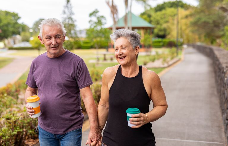 Senior Couple Walking Together in a Public Park