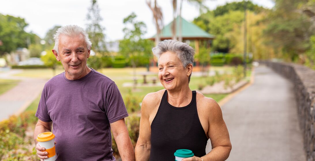 Senior Couple Walking Together in a Public Park