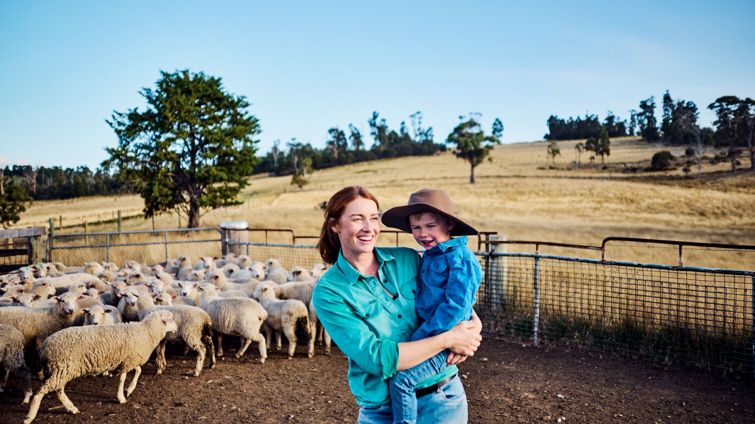 In the embrace of a tight-knit family, a resilient female farmer in Tasmania imparts the essence of sustainability and love for the land, weaving together the threads of agriculture, family values, and the care of their beloved sheep on their Australian farm.