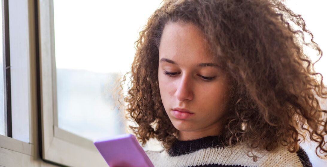 Person unsure looking at their phone