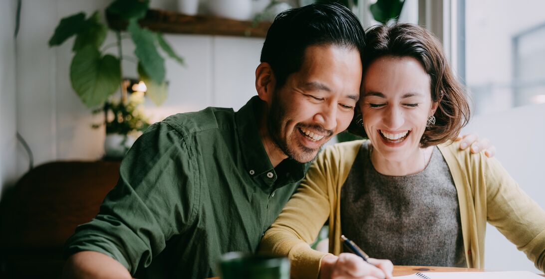 Happy couple planning and designing their future home