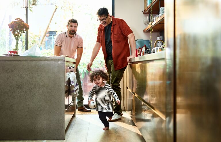 Gay couple with their son enjoying family time at home during lockdown, childhood, connections, in the moment