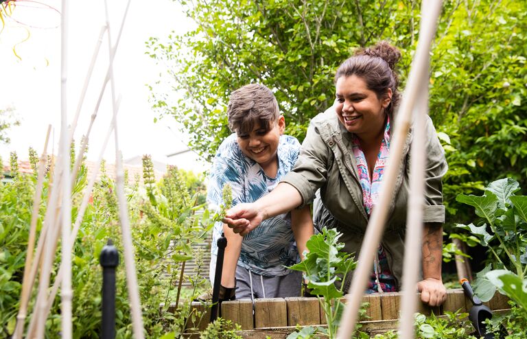 Indigenous Australian family with 2 children living a sustainable suburban Australian lifestyle.